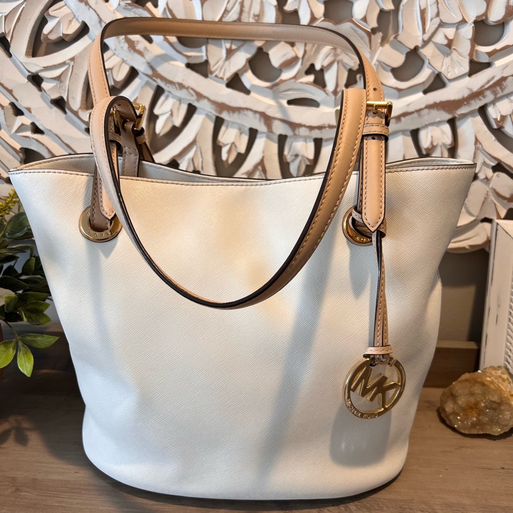 Michael Kors creamy white leather tote with tan straps and gold accents.